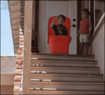 Kid-pushed-plastic-bin-stairs