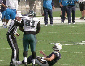 A football player is denied help getting off the ground from an opponent