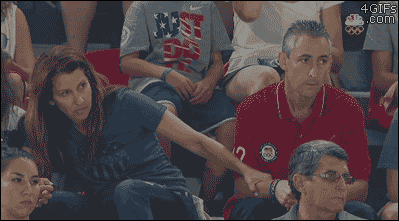 Nervous parents watch their daughter perform at the Olympics