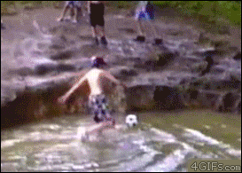 A kid is playing in a lake when his friend swinging on a rope knocks him over