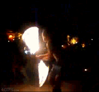 A fire twirler accidentally throws his baton into the audience