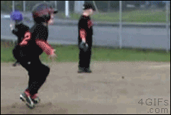 First baseman in little league isn't paying attention and lets a ball roll right past him