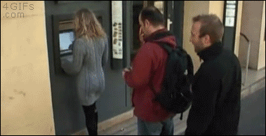 A man in line spanks a woman at an ATM and she slaps the man directly behind her