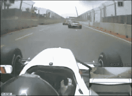 A race car flies over the head of a driver during a race