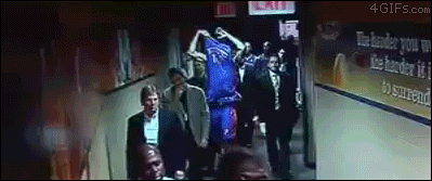 Angry basketball player throws his jersey and it lands on the head of the guy behind him
