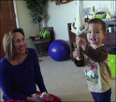 Kid tests out his new toy sword on his mom's face