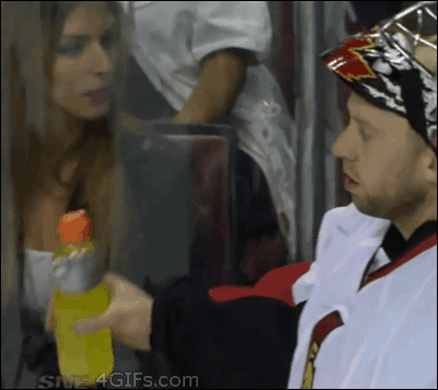 A woman is grossed out by a hockey player spitting gatorade