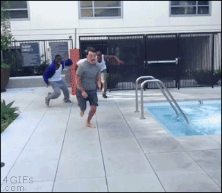A guy escapes being chased by 3 black guys by going into a pool
