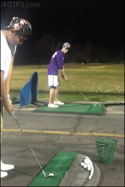 A guy hits a golf ball out of the air that his friend just hit