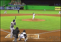 A baseball batter is in disbelief when the pitcher catches the ball he just hit