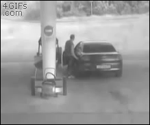 A truck flips over at a gas station and a man leaves instead of helping