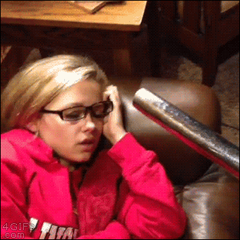 A sleeping girl is woken up by a vacuum sucking her lips