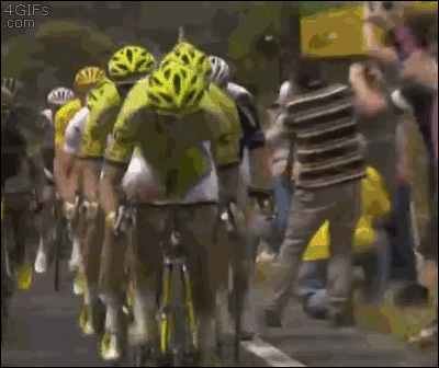 A cyclist hits a spectator who is standing in the way of the race