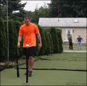 A guy flips around a baseball bit before hitting the ball