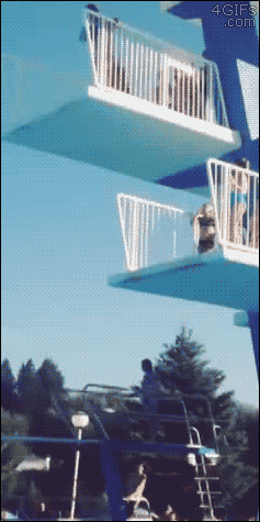 A girl changes her mind about jumping off the high dive but then falls anyway