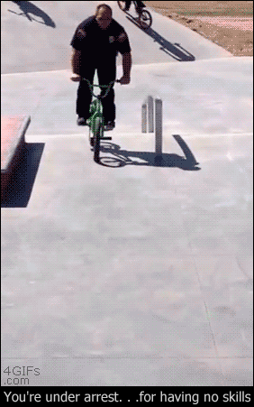 A cop does a 360 turn trick on a BMX bike