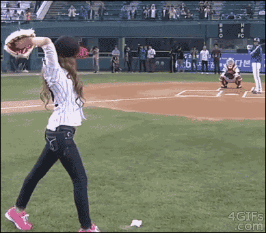 A girl fails badly at pitching a baseball