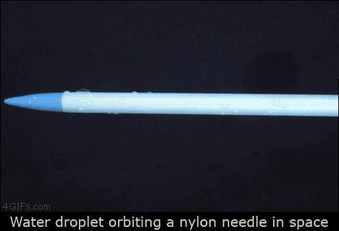 Water droplet orbiting a nylon needle in space