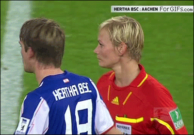 A soccer player accidentally swipes the chest of a female referee