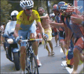 A cyclist elbows a girl who is standing in the way of the race