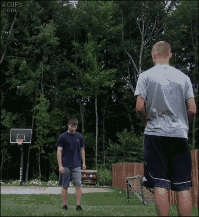 While doing a backflip a guy kicks a basketball into the basket