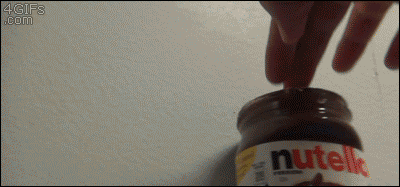 A guy in a bathroom stall uses Nutella to mimic poop and wipes it on someone's hand
