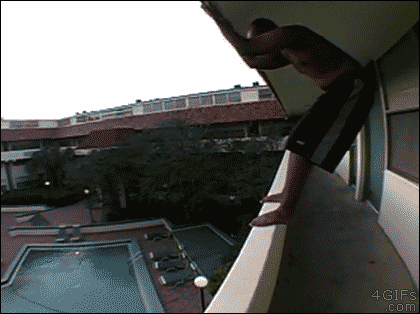 A guy bellyflops into a pool from a dangerous height and distance