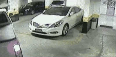 A truck moves an improperly parked car out of the way