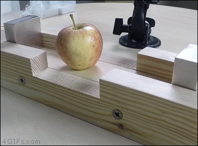 Magnets smash together and obliterate an apple between them