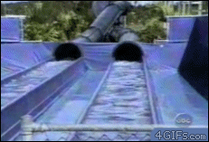 A man exits a water slide hydroplaning