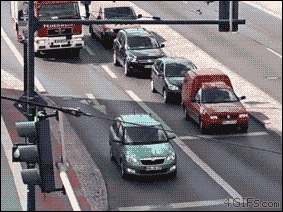 A driver is oblivious to a fire truck behind their car