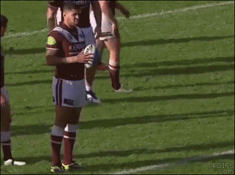 A rugby player is oblivious to his crotch being grabbed by an opponent