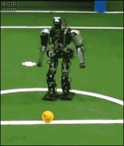 A robot attempts to kick a soccer ball