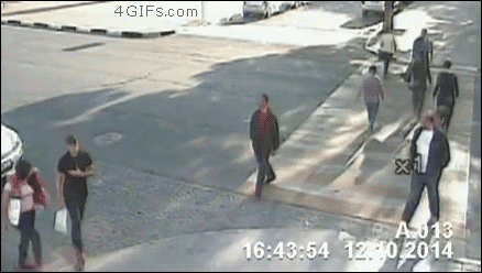 A man stops a bicyclist from getting hit by a car