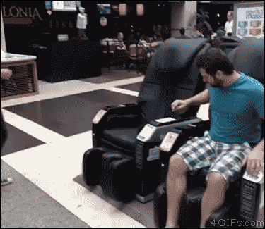 A troll pretends to get shocked by a massage chair to scare a girl