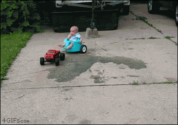An RC truck pulls a baby in a bumpo