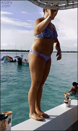 A woman tries to do a backflip off the edge of a boat