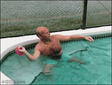 A guy catches a swimming cap on his head