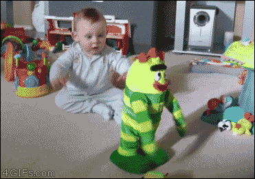 A baby has fun with a dancing toy