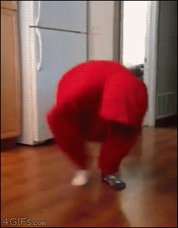 A girl doing the ostrich dance while dressed as a hoodie monster falls on her face