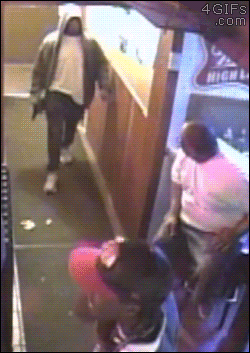 A bouncer elbows a man entering with a gun and chases him off