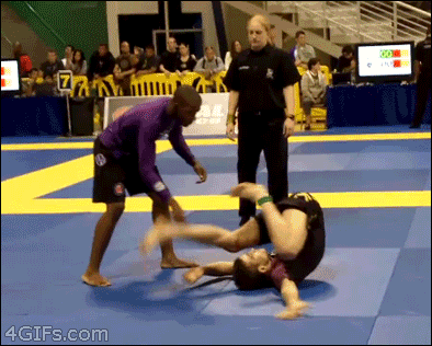 Wrestler is not impressed with his opponent's bizarre upside down scooting