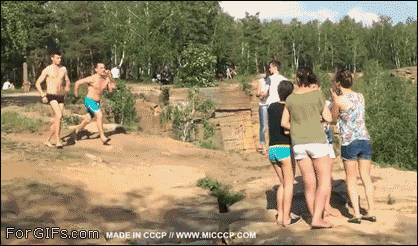 A guy attempts a cliff jump