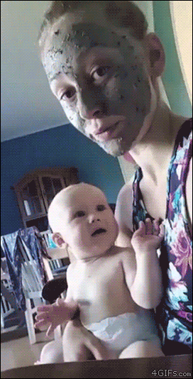 A baby is scared by a mud mask