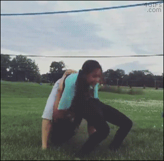 A girl trying gymnastics does a piledriver